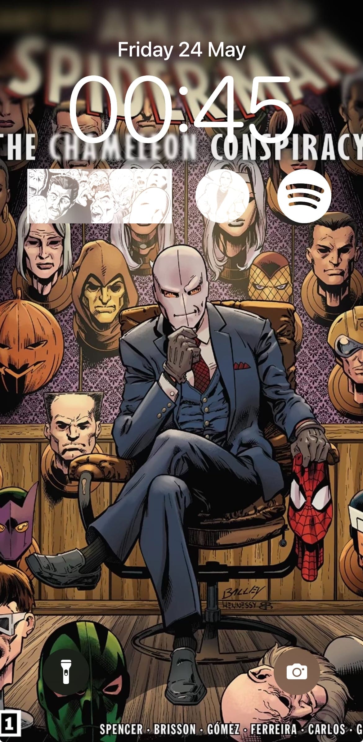 Screenshot of phone lockscreen, the wallpaper being Chameleon lounging in a chair holding Spidey's mask. Behind him are a dozen masks hung on the wall. There are three widgets, one being Spotify and the two others being comic panels.