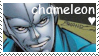 A close up of Chameleon grinning in a blue suit, with white text reading 'chameleon' and a white heart below it, surrounded by a white stamp border.